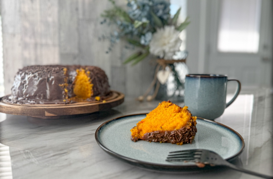 Slice of Brazilian carrot cake with brigadeiro topping.