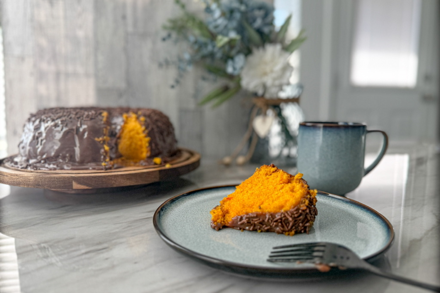 Slice of Brazilian carrot cake with brigadeiro topping.