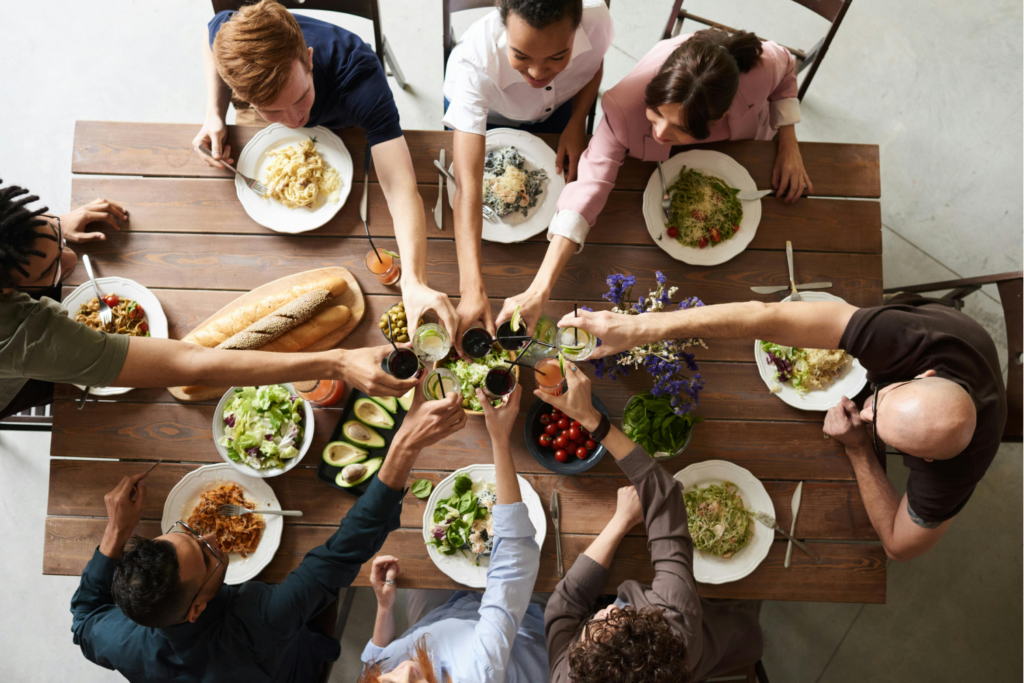 View from above of a family toasting at the table