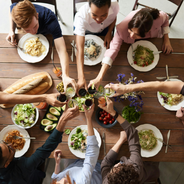 View from above of a family toasting at the table