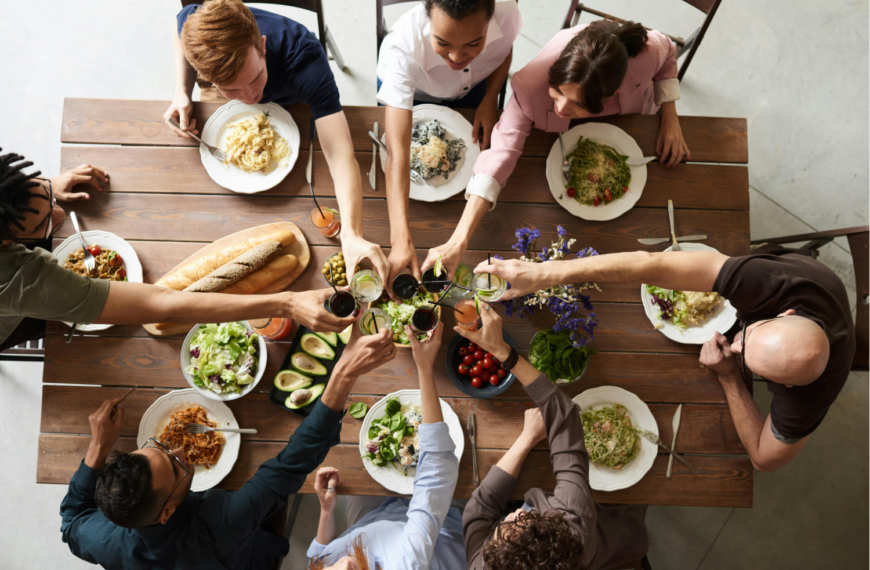View from above of a family toasting at the table