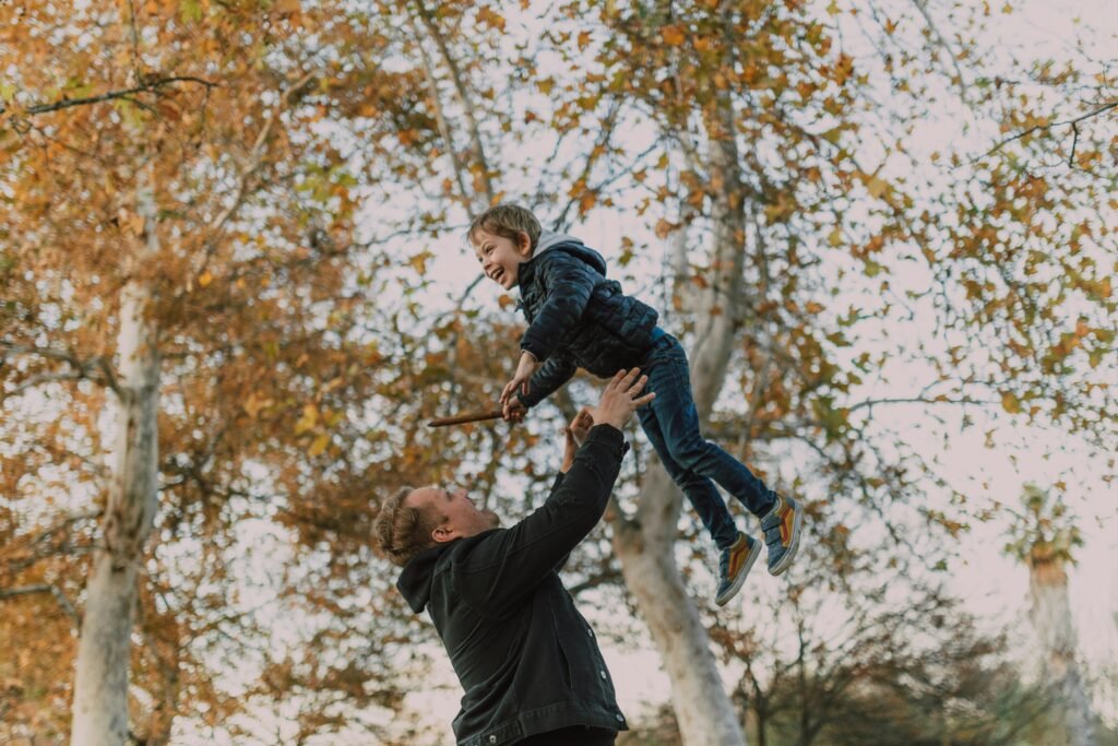 father throwing his son up