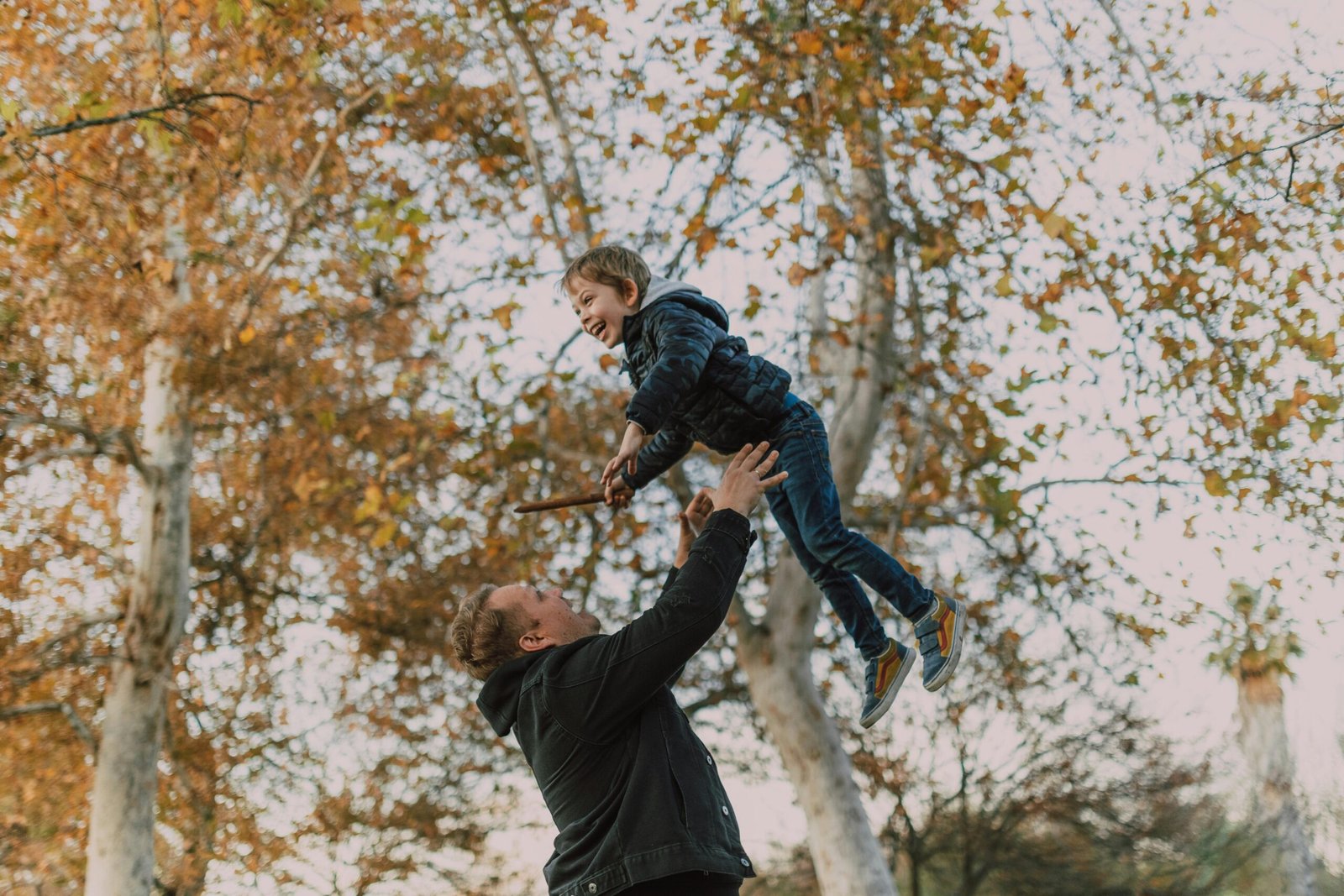 father throwing his son up