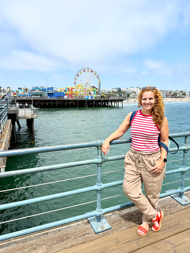 santa-monica-day-1 Woman in cargo pants and tank top smiling at Santa Monica Pier