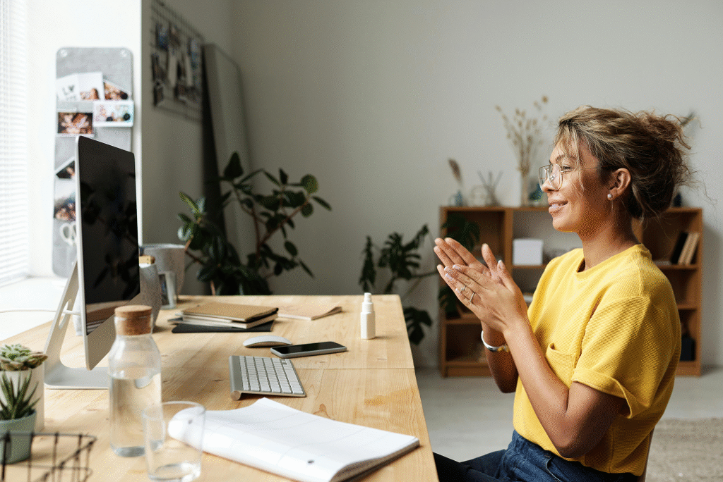 Woman in front of computer working happy.
