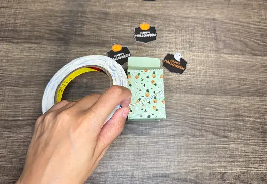 Closing and decorating the Halloween Treat Bags..