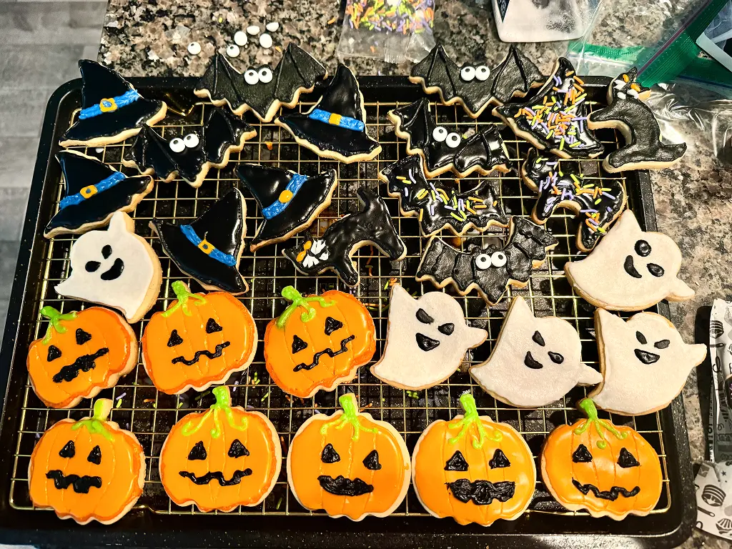 Decorated halloween cookies in several shapes.