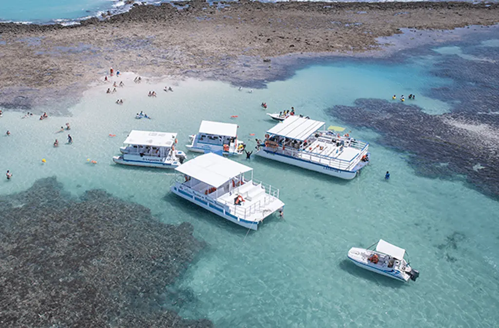 Ferries and boats floating on a crystal-clear ocean
