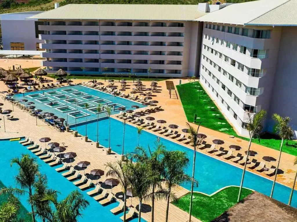 Aerial view of the hotel with large outdoor swimming pools