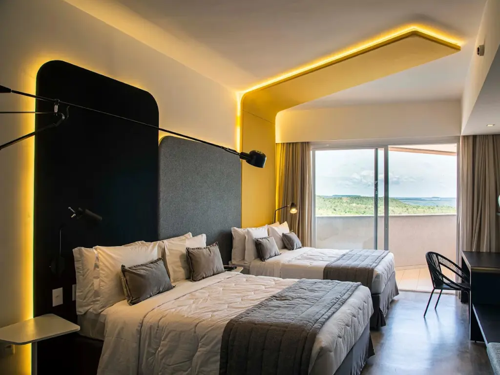 Hotel room with two double beds, study desk, and LED lights