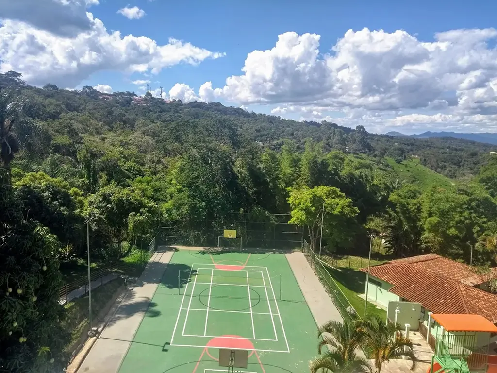 Brazilian Resorts: Sports court with basketball hoops and volleyball net seen from above